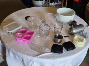 Kitchen Measuring and Storage Items including Measuring Cups, Bowls, and Containers