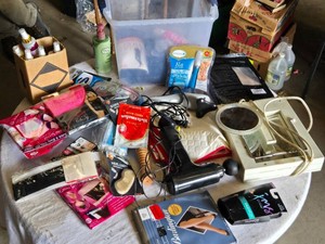 Various personal care and beauty products, including Bliss in a Bottle Lotion, Body Dew Silky Body Oil, a percussion massager, and a Pedi Perfect foot care device.