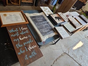 Home decor wall art collection including various framed quotes and artwork