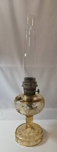 Antique Aladdin Kerosine Stand Lamp in the Washington Drape pattern featuring a distinctive amber-colored glass font. Manufactured around the 1940s and has the brass Aladdin Cap side refill. side.&nbsp Very collectible. 25Tall.