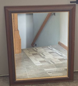 Mirror with wooden trim.&nbsp The mirror is 27 w x 33 l.