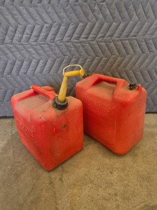 TWO RED GAS CANS