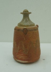 vintage stoneware jug contains lamp oil
