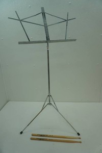 music stand and a pair of Ludwig drum sticks