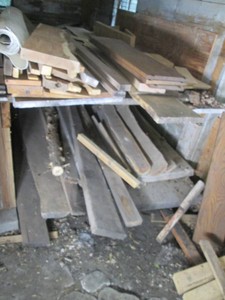 Two shelves of wood planks, some li...