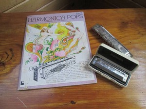 Pair of vintage harmonicas with har...