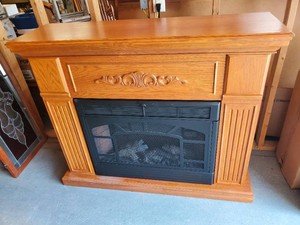 Twin Star Electric Fireplace with Wood Finish Mantel and decorative Carvings