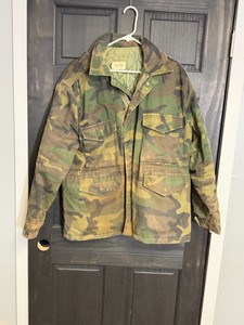 M-52 -style field jacket featuring a camouflage pattern and a quilted interior liner