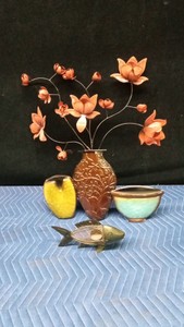 Floral metal plaque and a fish metal candle holder