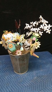 Metal bucket of metal decorative garden stakes