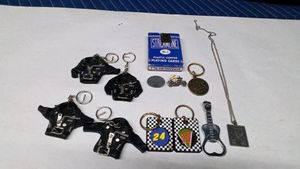 Lot of key rings, pins, naughty necklace, guitar bottle opener and cards