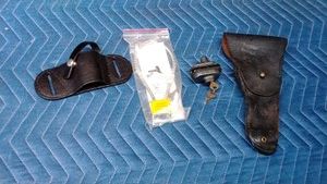 2 leather pistol holsters and 2 gun locks with keys