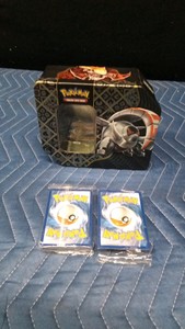 2 Unopened packs of Pokemon cards in a Pokemon tin