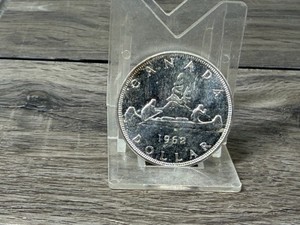 1962 Canadian Voyageur Silver Dollar featuring a canoe with two paddlers