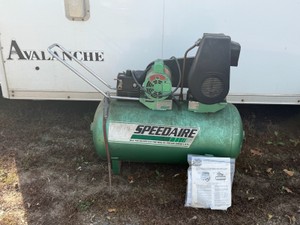 Green, wheeled, belt-driven Speedaire portable electric air compressor (manufactured for Dayton Electric Mfg. Co.)
