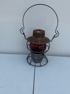 Vintage Dressel Arlington, N.J. railroad hand-signal lantern equipped with a red glass globe and an arched metal bail handle