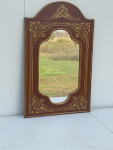 Queen Anne-style red lacquer and gold parcel-gilt Chinoiserie wall mirror with a shaped frame and oriental-inspired stenciled or japanned detailing.