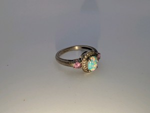 Sterling Silver 925 oval cabochon-cut white lab created opal center stone, flanked by accent pink and white sapphire, size 6.5