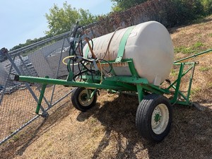 Two-Wheel, 500 Gallon Tank with Two Fold-Out Sprayer Arms for applying herbicides in the farm fields.