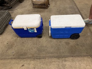 One Igloo Cooler with Wheels (22 x 15 x 16) and One Coleman Cooler with Wheels (23.5 x 13 x 16)