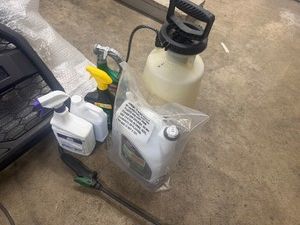 Full and Partially Full Bottles of Weed Killer with Sprayer