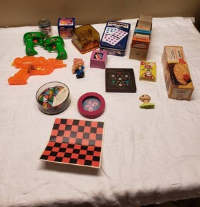 Various Toys and Games Collection Including Water Guns, Dominoes, and Puzzles