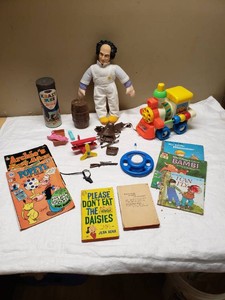 Mixed vintage toys and books including Popeye and Archies Family Album comic books, Jean Kerrs book, and vintage Fisher-Price toys.