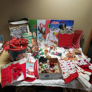Holiday decorations and accessories including red bows, Santa hats, tinsel, poinsettias, and various Christmas-themed items