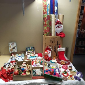 Holiday ornaments, decorations, and wrapping supplies including vintage teddy bear figurines and wrapping paper