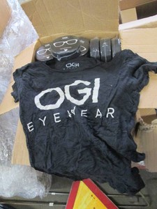 Case of OGI Eyewear shirts, in hockey puck compact packaging, size L