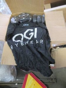 Case of OGI Eyewear shirts, in hockey puck compact packaging, size XL