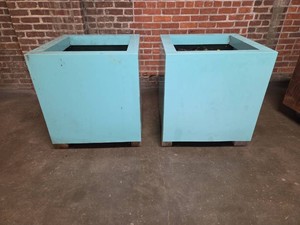 Set of 2 light blue square metal planter boxes.