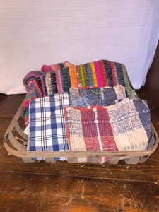 Vintage basket holding vintage woven textiles