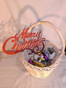 White wicker basket of Christmas decorations
