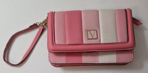 Victorias Secret  The Victoria Tech Wristlet in a pink striped pattern.  Faux leather construction, gold-toned hardware, and a branded V logo on the front flat.  Wristlet is designed to hold credit cards, cash, and a smartphone.