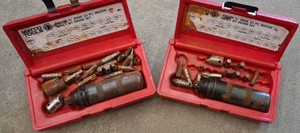 2 RED CASES WITH 2 IMPACT DRIVERS AND PARTS