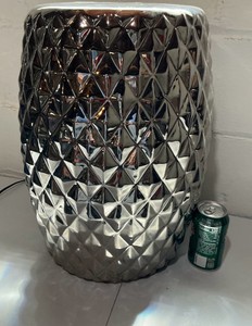 Silver diamond patterned garden stool with a cut out coin motif