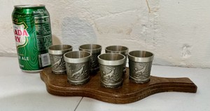 Vintage set of West German SKS Zinn pewter hunting relief shot glasses, wooden wall paddle
