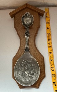 Vintage German Frieling Zinn pewter collectors spoon on a wooden wall display