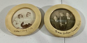 2 Round celluloid picture frames with pictures