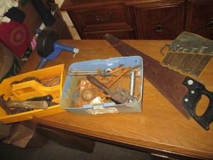 Hand tools in 2 plastic carriers and a drain snake