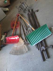 Yard tools, extension cord and bike pump with a metal rack