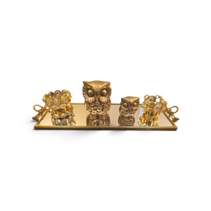 This is a gold-toned owl family and crystal-accented decor set arranged on a mirrored vanity tray