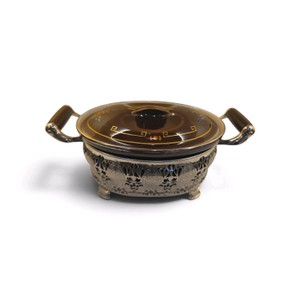 vintage brown vintage Regal-Rochester baking liner, manufactured by Guernsey Cooking Ware casserole dish featuring a decorative lidded design paired with an ornate silver-plated or aluminum filigree cradle stand and side handles