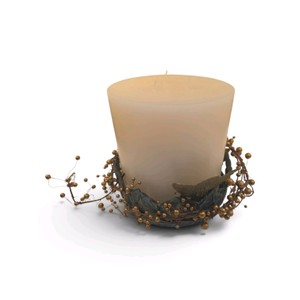 Decorative pillar candle is paired with a rustic gold pip berry and twig candle ring featuring a small bird accent