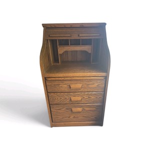 Solid oak rolltop secretary desk features a sliding tambour door and three lower storage drawers