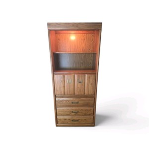 Bernhardt solid oak illuminated bookcase cabinet featuring upper shelving, double cabinet doors, and three lower drawers with recessed brass hardware. it measures 32.75 wide  18deep  77.5 tall PLEASE BRING HELP TO MOVE THIS