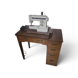 vintage Sears Kenmore electric sewing machine housed in a mid-century wooden cabinet desk with multiple side drawers. 1, 2