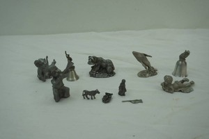 collection of pewter figurines and small bells