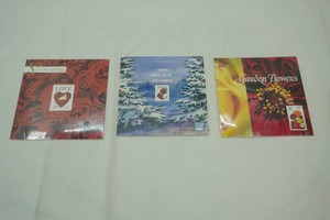 (3ct) Collectible Stamp Folios 1994 Holiday Stamps (opened) Love Stamp Folio (unopened) Garden Flowers Stamp Folio (unopened)